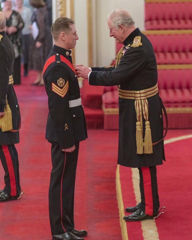Sam receiving his MBE